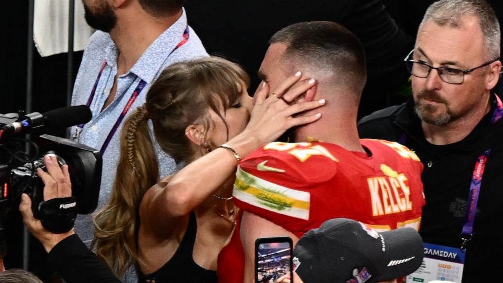 US singer-songwriter Taylor Swift kisses Kansas City Chiefs' tight end #87 Travis Kelce after the Chiefs won Super Bowl LVIII against the San Francisco 49ers at Allegiant Stadium in Las Vegas, Nevada, February 11, 2024. 