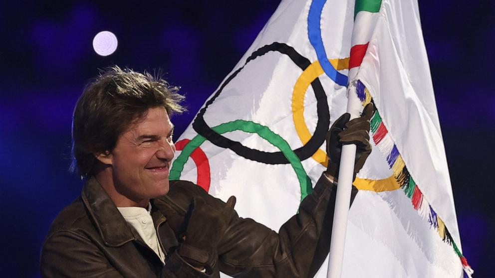 Tom Cruise waves the Olympic flag during the closing ceremony of the Paris 2024 Olympic Games at the Stade de France, in Saint-Denis, in the outskirts of Paris, on August 11, 2024. (Photo by FRANCK FIFE/AFP via Getty Images)