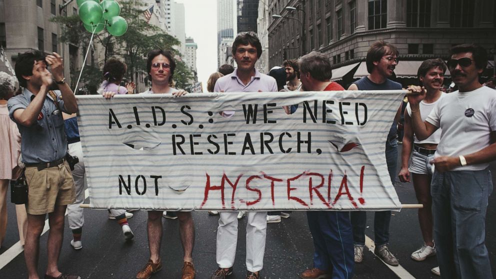 PHOTO: Marchers on a Gay Pride parade through Manhattan, New York City, carry a banner which reads 'A.I.D.S.: We need research, not hysteria!', June 1983.