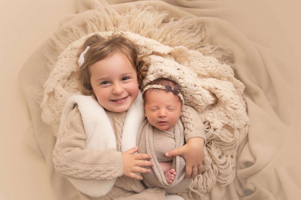 PHOTO: Molly Gibson and her sister Emma pose for a photo. Both were born from frozen embryos.