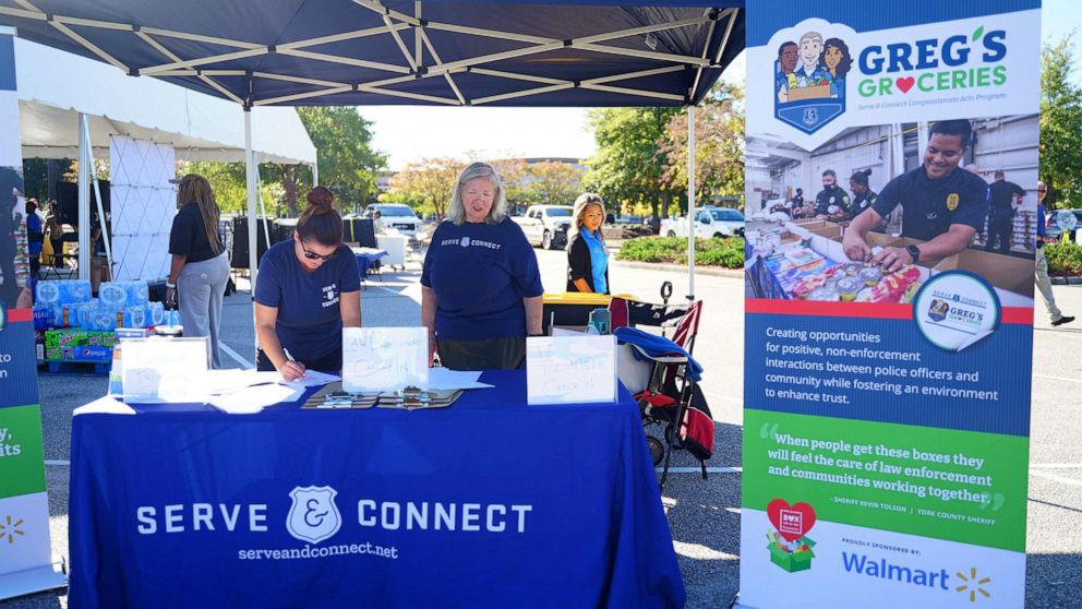 PHOTO: Volunteers stand at Serve & Connect information booth on Oct.5, 2022.