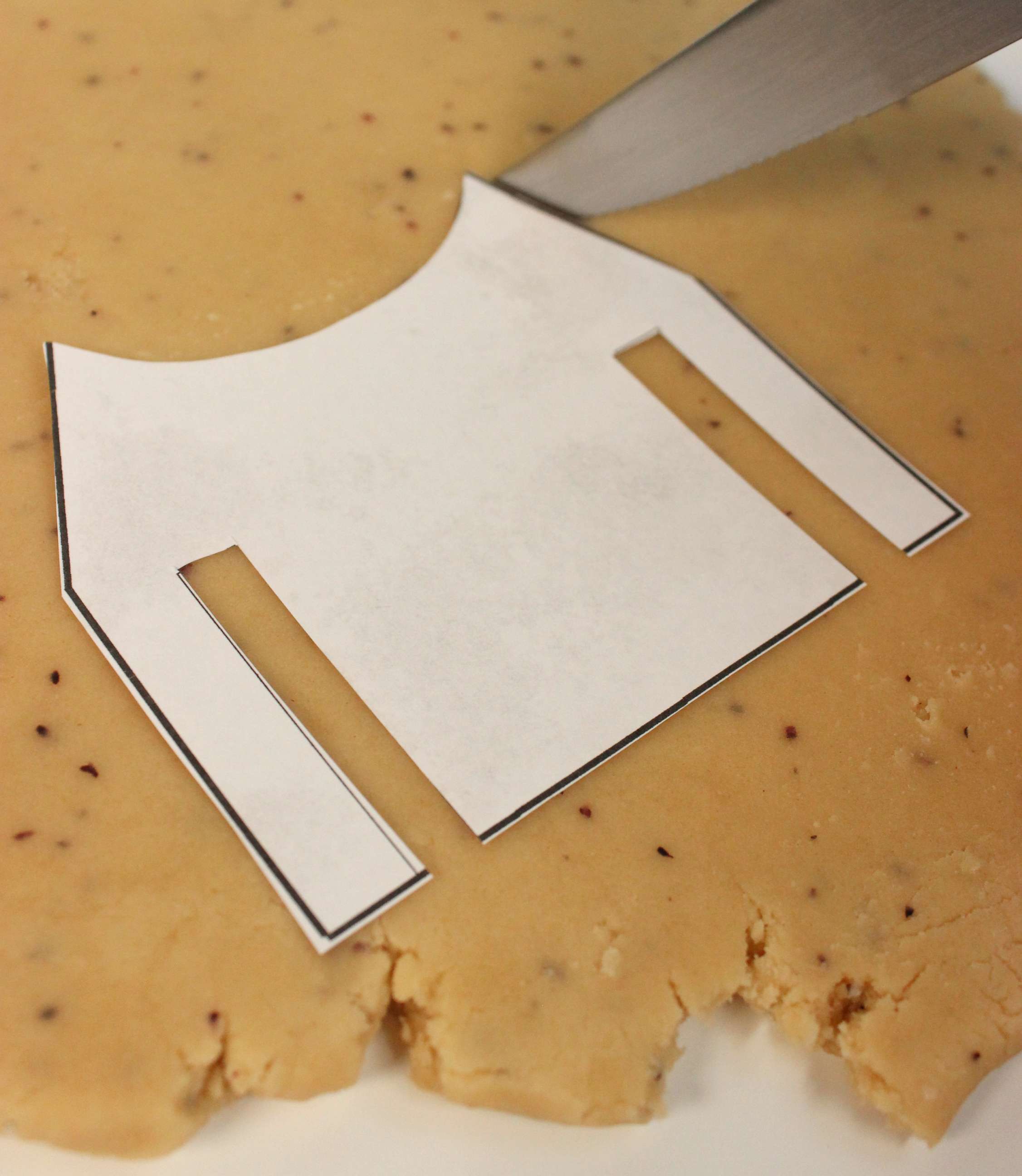 PHOTO: Grogu Tea Cookie template on top of brown cookie dough.