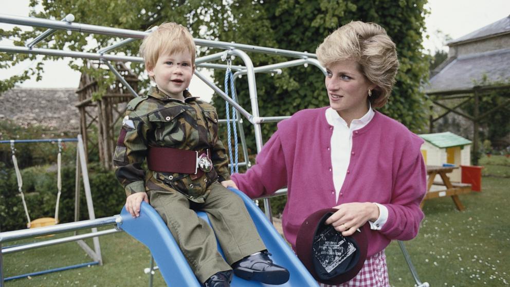 PHOTO: Prince Harry wearing the uniform of the Parachute Regiment of the British Army in the garden of Highgrove House in Gloucestershire, 18th July 1986. He is accompanied by his mother, Diana, Princess of Wales (1961 - 1997). 