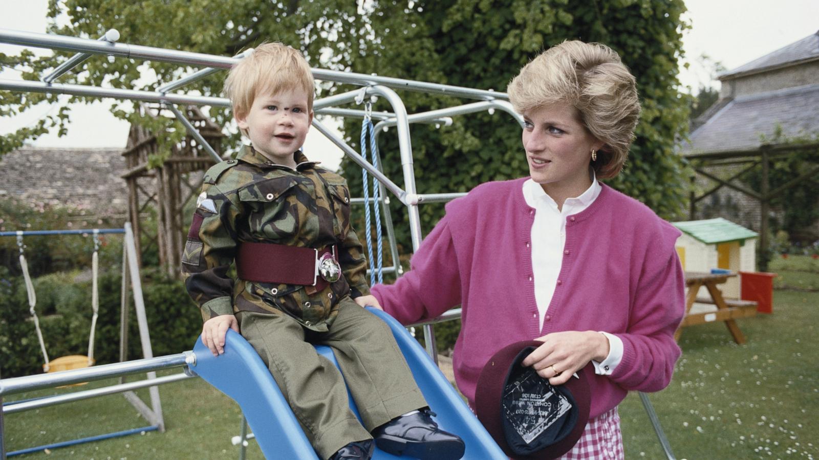 PHOTO: Prince Harry wearing the uniform of the Parachute Regiment of the British Army in the garden of Highgrove House in Gloucestershire, 18th July 1986. He is accompanied by his mother, Diana, Princess of Wales (1961 - 1997).
