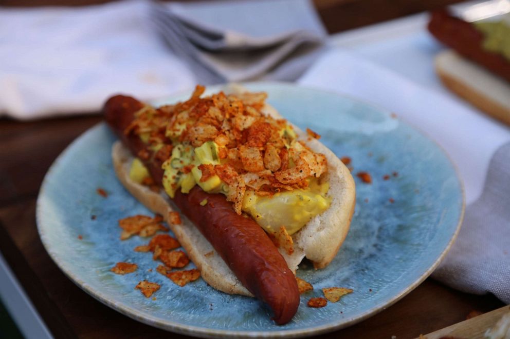PHOTO: Hot dog topped with potato salad and BBQ chips.