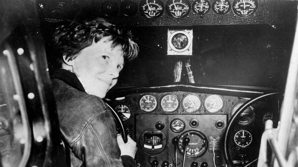 PHOTO: Amelia Earhart in the cockpit of a plane. 
