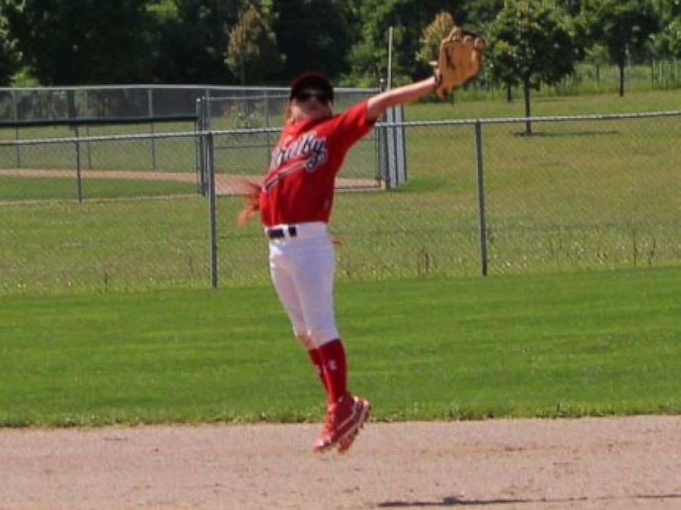 PHOTO: Ashlynn Therien makes a diving catch during a baseball game in Toronto, Canada.