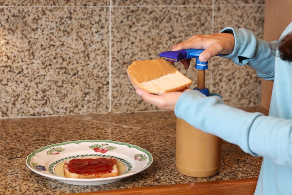 PHOTO: The Peanut Butter Pump dispenses a wide flat ribbon of peanut butter onto bread for a sandwich. 