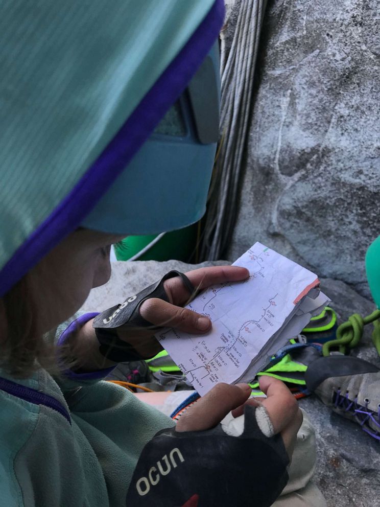 PHOTO: Selah Schneiter looks at her notes as she climbs El Capitan at Yosemite National Park in California.