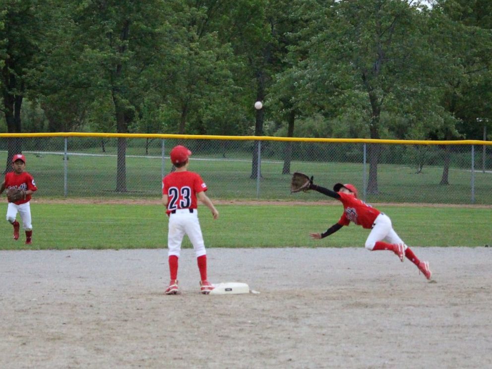 PHOTO: Ashlynn Theiren makes a diving catch playing baseball for the Whitby Chiefs.
