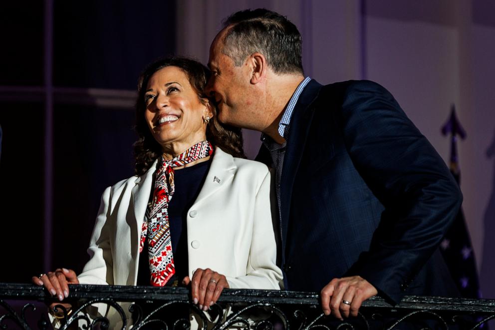 PHOTO: Second Gentleman Doug Emhoff whispers to Vice President Kamala Harris as they watch the fireworks from the White House balcony during a 4th of July event at the White House in Washington, DC, July 4, 2024.