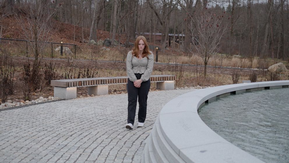 PHOTO: Jackie Hegarty, a survivor of the 2012 shooting at Sandy Hook Elementary School, visits the Sandy Hook Permanent Memorial in Newtown, Connecticut.
