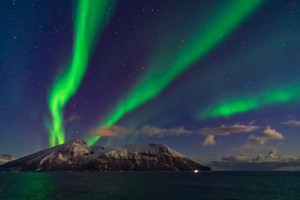 PHOTO: A display of aurora in curtains across the north, observed from the upper Deck 9 of the MS Trollfjord on the southbound voyage north of Tromsa, along the Norwegian coast, Oct. 19, 2019. 