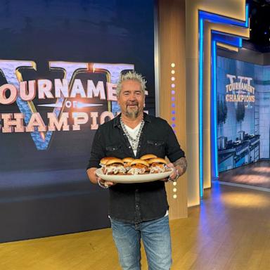 PHOTO: Food Network host Guy Fieri holds a platter of chicken sandwiches on "GMA."