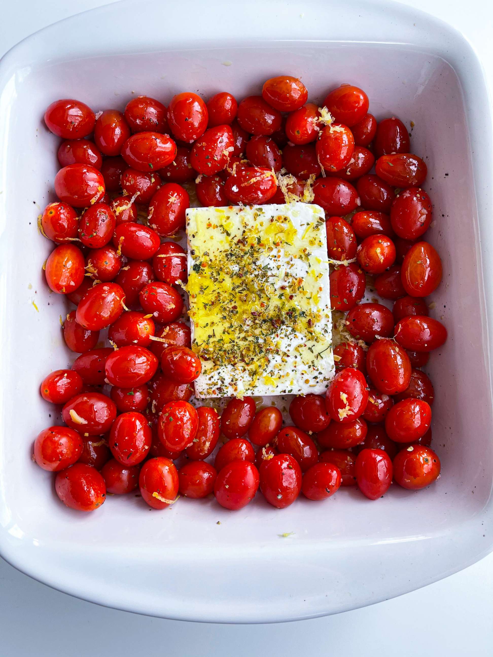 PHOTO: Tomatoes, feta cheese, herbs, olive oil and lemon zest ready to be roasted in the oven.