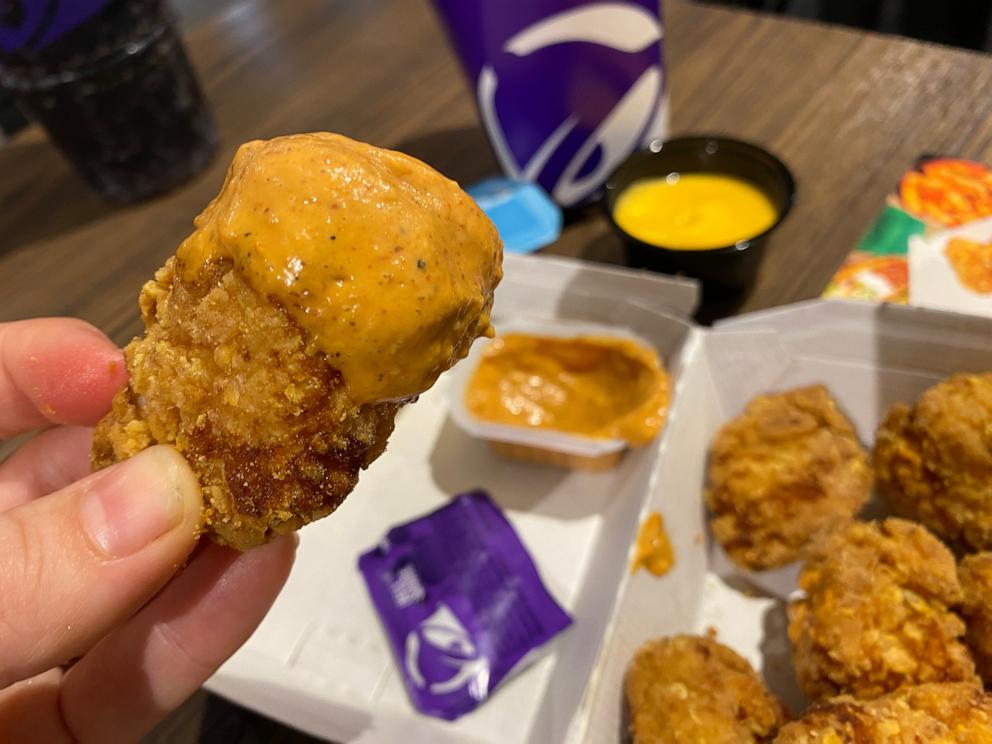 PHOTO: A crispy chicken nugget with bell sauce from Taco Bell.