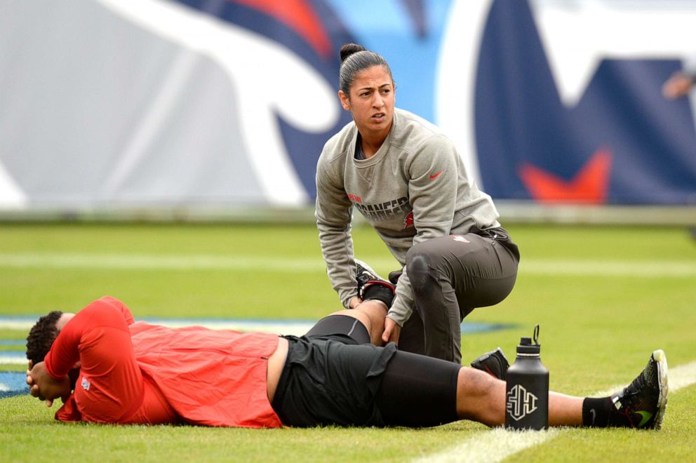 PHOTO: Tampa Bay Buccaneers assistant strength and conditioning coach Maral Javadifar works with nose tackle Ndamukong Suh before an NFL football game against the Tennessee Titans, Oct. 27, 2019, in Nashville, Tenn. 