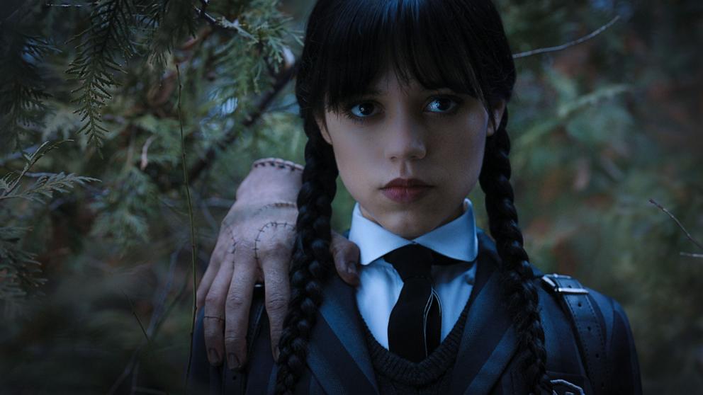 full body of a Wednesday Addams (Jenna Ortega) and uncle Fester