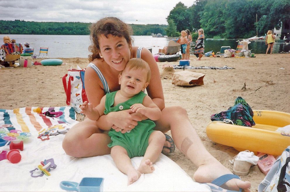 PHOTO:  Jodi Picoult is pictured at 26-years-old holding her son Kyle while spending time on the beach.