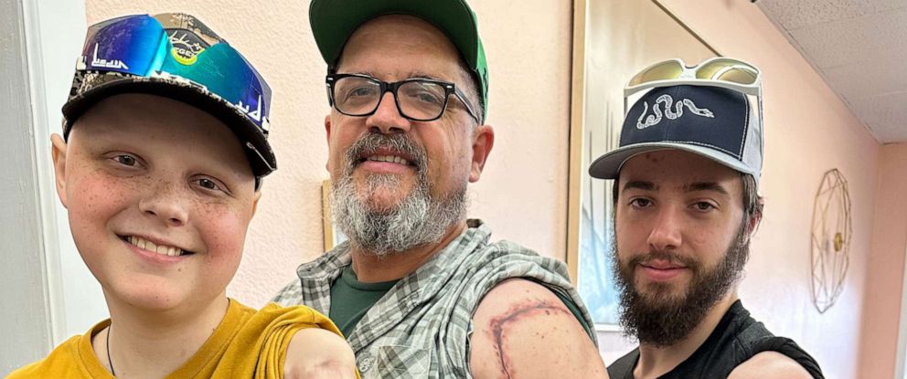 PHOTO: Jody OBriant (center) and his eldest son, Nathan (right), both received tattoos along their left arms. The tattoos match the scar OBriants youngest son Jasper has from his cancer treatment.