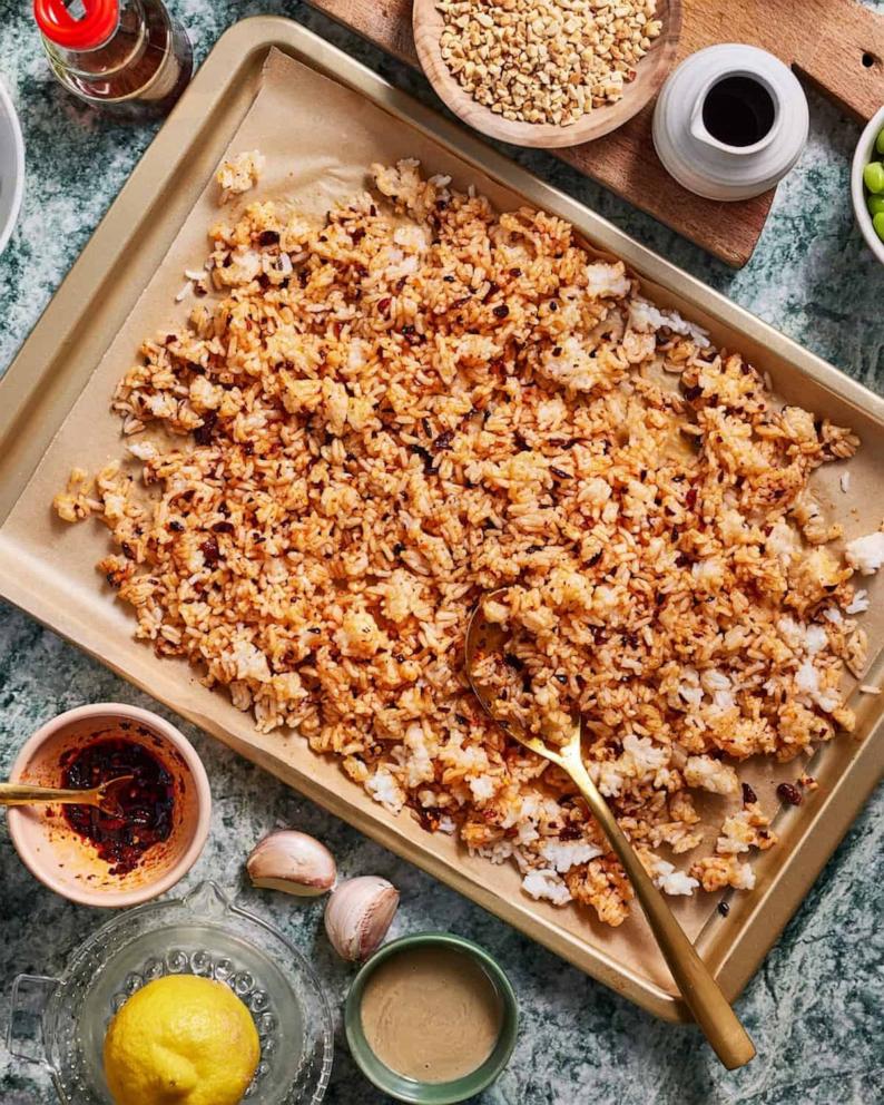 PHOTO: A sheet tray of white rice with seasoning prepared for the oven.