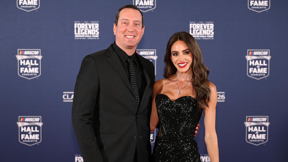 PHOTO: NASCAR Cup Series driver, Kyle Busch and wife, Samantha Busch pose for photos on the red carpet prior to the NASCAR Hall of Fame Induction Ceremony at Charlotte Convention Center on January 23, 2026 in Charlotte, North Carolina. 