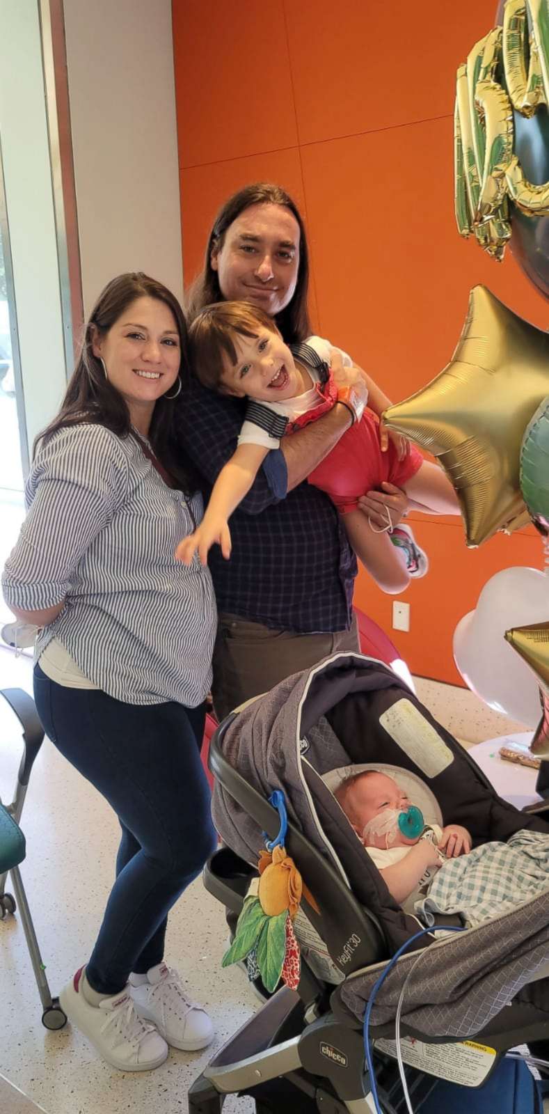 PHOTO: Valerie Kasper poses with her partner Steven and their two children on the day their youngest son, Theodore, went home from the NICU.
