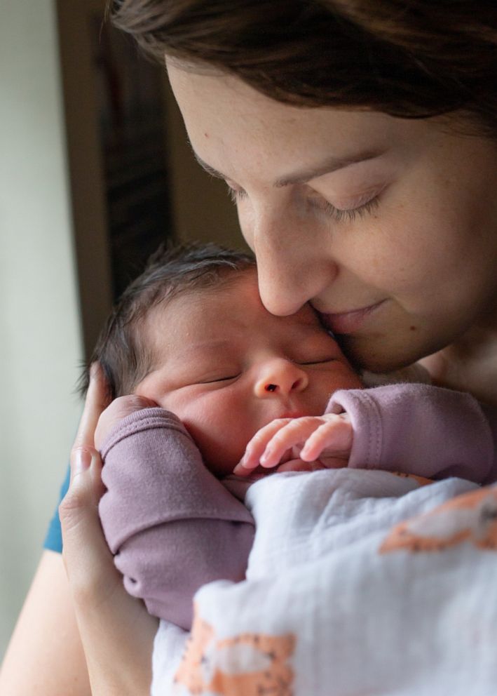 Katy Sanchez holds her baby, who was delivered via surrogacy. 