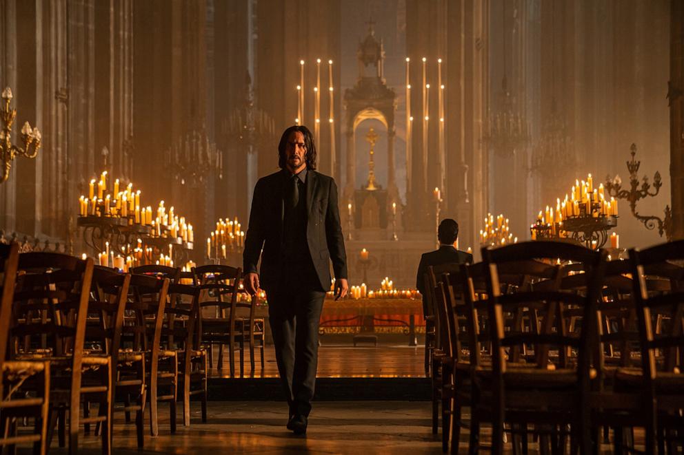 PHOTO: Keanu Reeves walks along an aisle in the Church of Saint-Eustache, in a scene from the film 'John Wick: Chapter 4' (directed by Chad Stahelski), Paris, France, October 2021. 