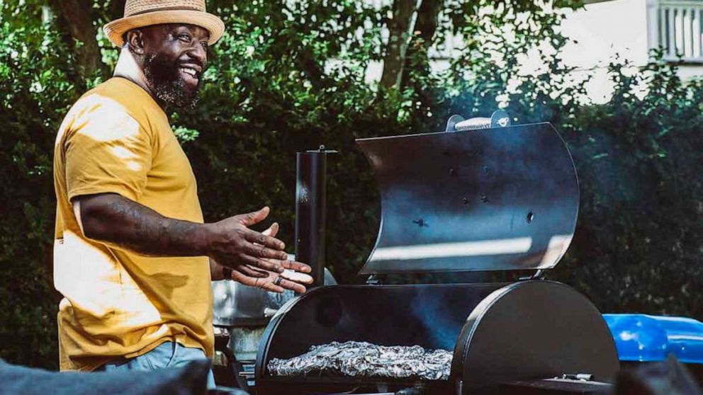 Chef making burger. Beef or pork meat barbecue burgers for hamburger  prepared grilled on bbq fire flame grill. Close-up shot of chef's hands  turn the chop on the grill Stock Photo