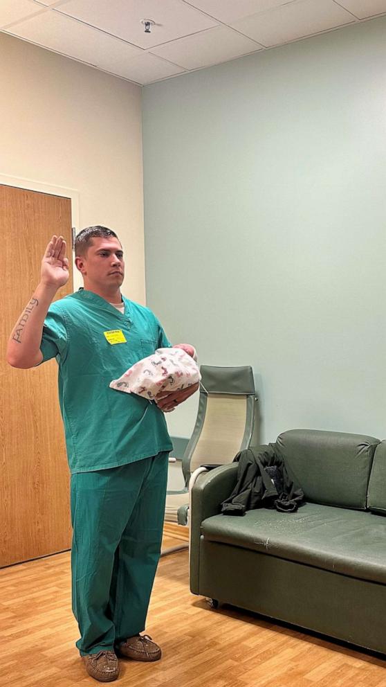 VIDEO: Police officer sworn in at hospital while holding newborn son 