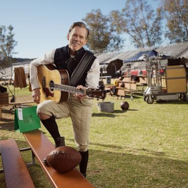 PHOTO: Kevin Bacon plays the guitar on set for a new Super Bowl campaign with Uber Eats called "Century of Cravings."