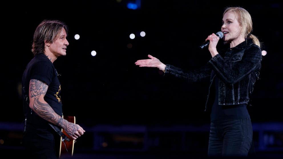 PHOTO: Keith Urban and Nicole Kidman speak onstage at the Concert For Carolina Benefit Concert at Bank of America Stadium in Charlotte, NC, Oct. 26, 2024.