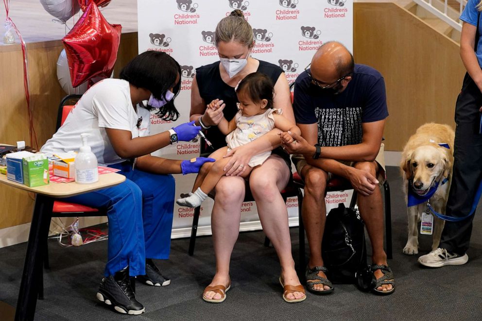 PHOTO: Registered nurse Reisa Lancaster, left, administers a dose of a Pfizer COVID-19 vaccine to Ada Hegde, age 14 months, at Children's National Hospital's research campus, June 21, 2022, in Washington, D.C. 