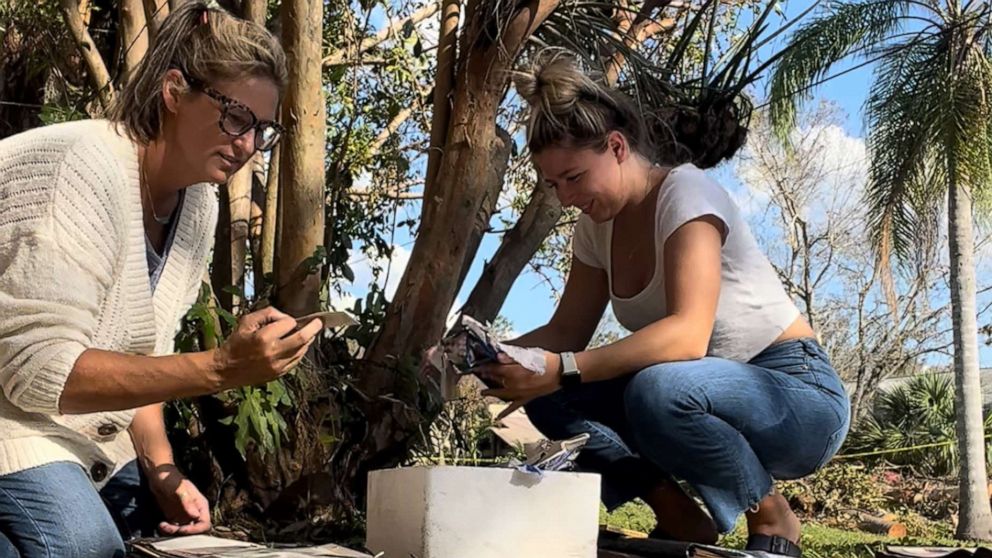 PHOTO: Krista Kowalczyk, owner of Impressions Photography, works with her assistant Maddie Briggs to recover photographs in Fort Myers, Florida, after Hurricane Ian.