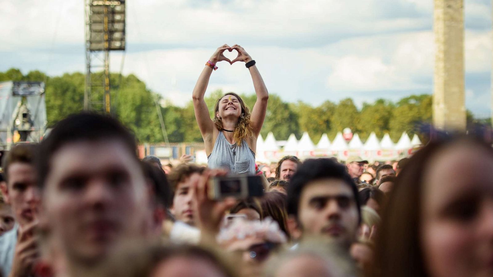 PHOTO: A visitor forms a heart with her two hands in the audience at the Lollapalooza Festival in the Olympic Park, Sept. 8, 2019, in Berlin.