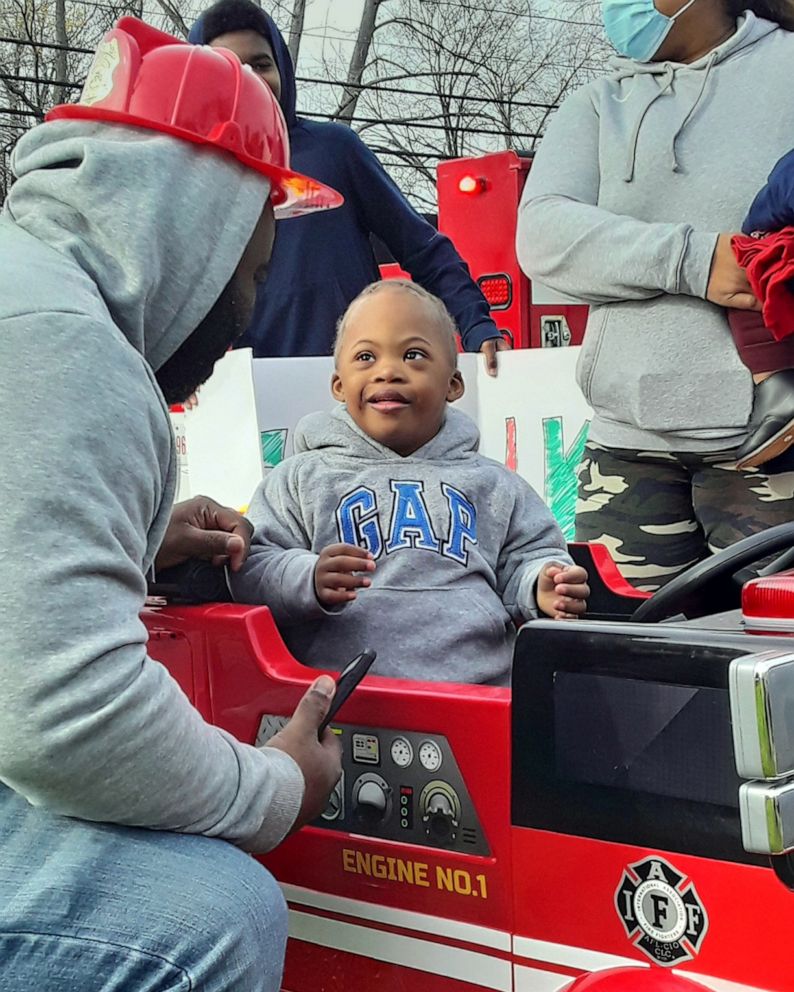 PHOTO: Cameron Peete sitting in his brand new toy firetruck.