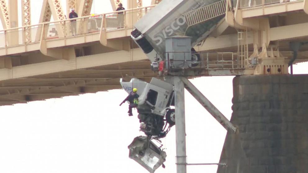 VIDEO: Firefighter lifts driver hanging over Ohio river bridge to safety