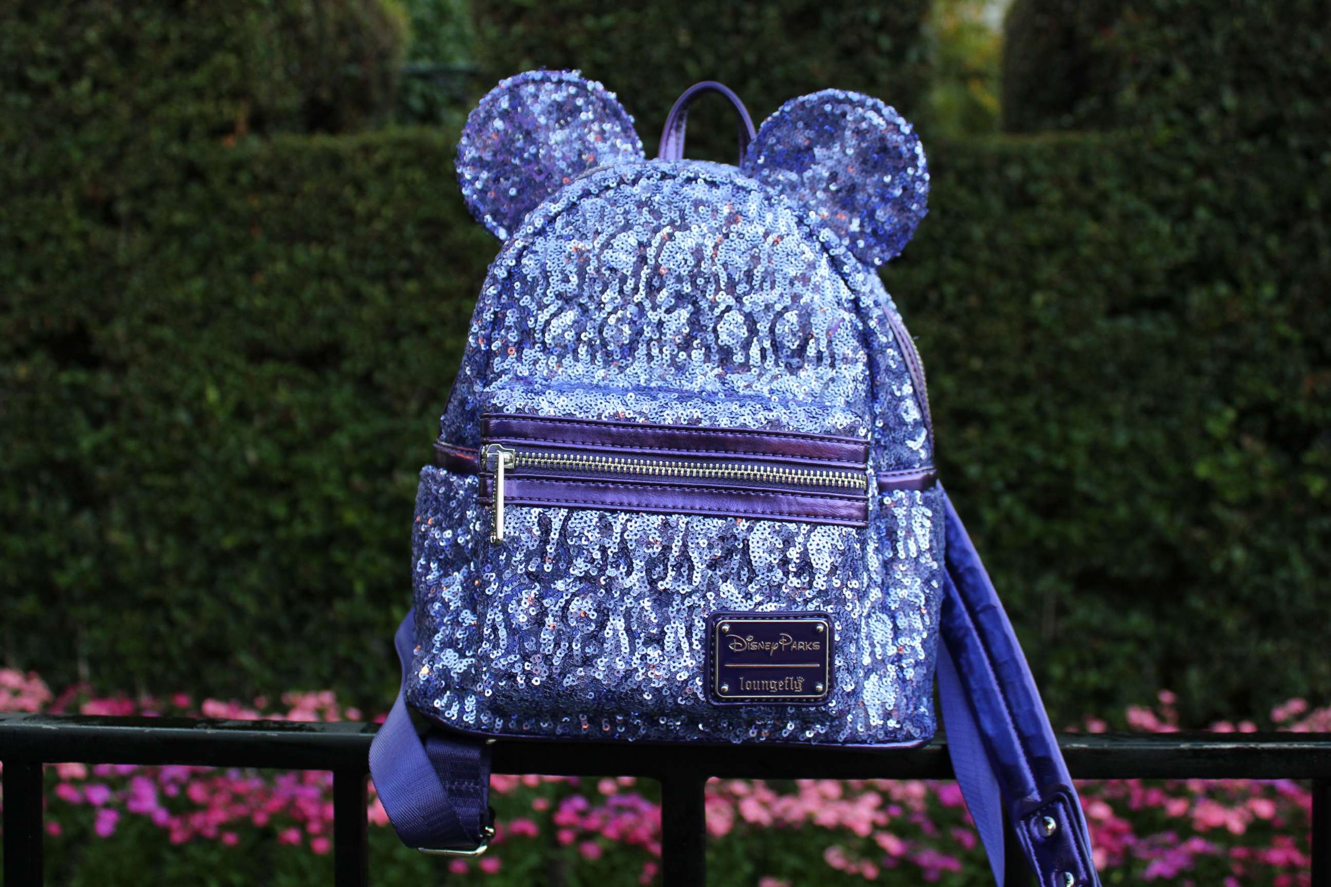 PHOTO: The Loungefly Potion Purple Mini Backpack features a glamorous sequined design and Minnie ears with her signature bow.