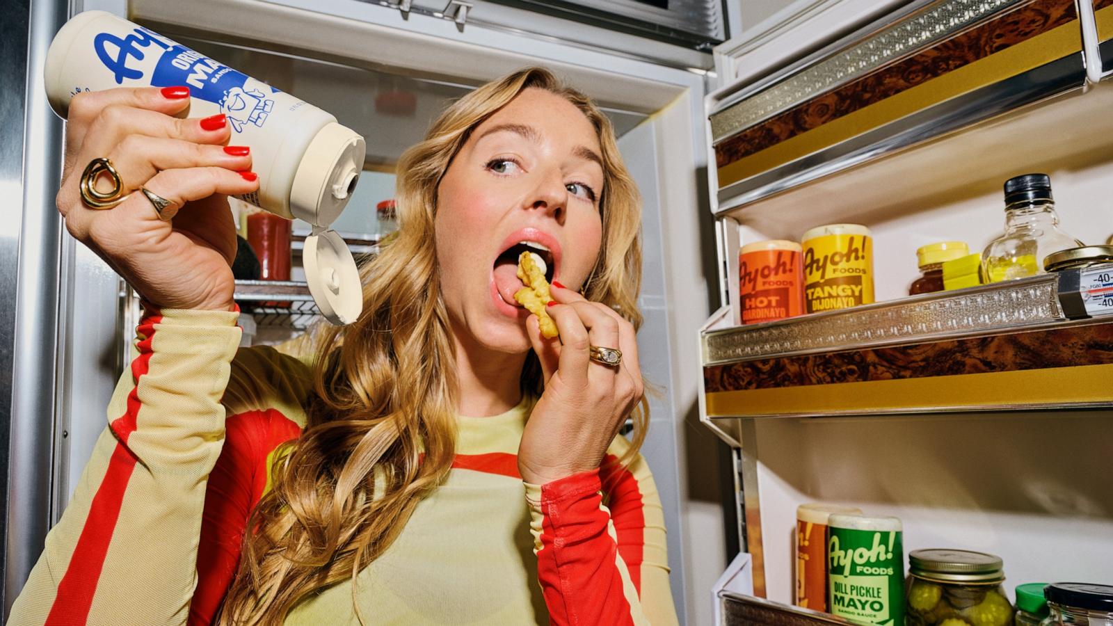 PHOTO: Molly Baz eats french fries with her new condiment, Ayoh.