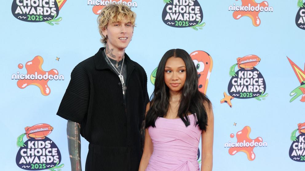 US rapper Machine Gun Kelly (L) and Casie Baker attend the Nickelodeon Kids' Choice Awards in Santa Monica, California on June 21, 2025. 