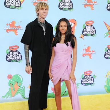 US rapper Machine Gun Kelly (L) and Casie Baker attend the Nickelodeon Kids' Choice Awards in Santa Monica, California on June 21, 2025. 
