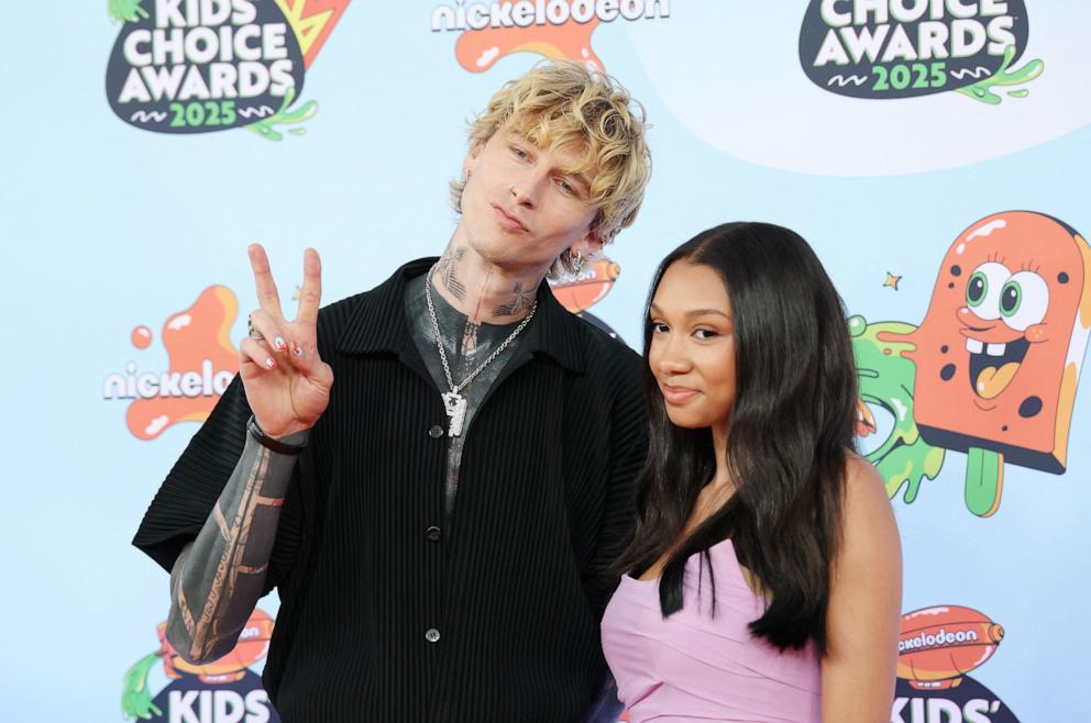 US rapper Machine Gun Kelly (L) and Casie Baker attend the Nickelodeon Kids' Choice Awards in Santa Monica, California on June 21, 2025. 