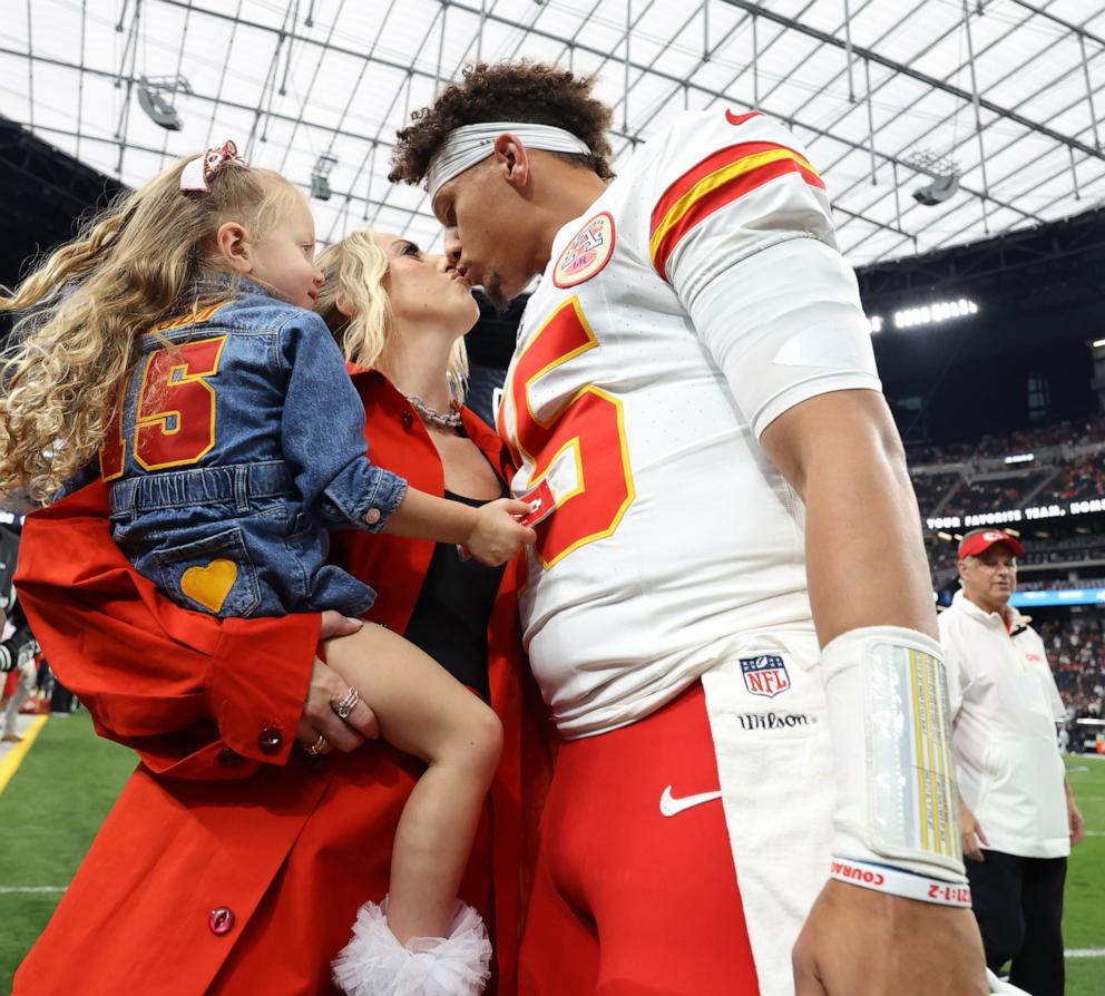 PHOTO: Patrick Mahomes kisses his wife, Brittany, while their daughter, Sterling, watches prior to a game against the Las Vegas Raiders at Allegiant Stadium on Oct. 27, 2024 in Las Vegas.