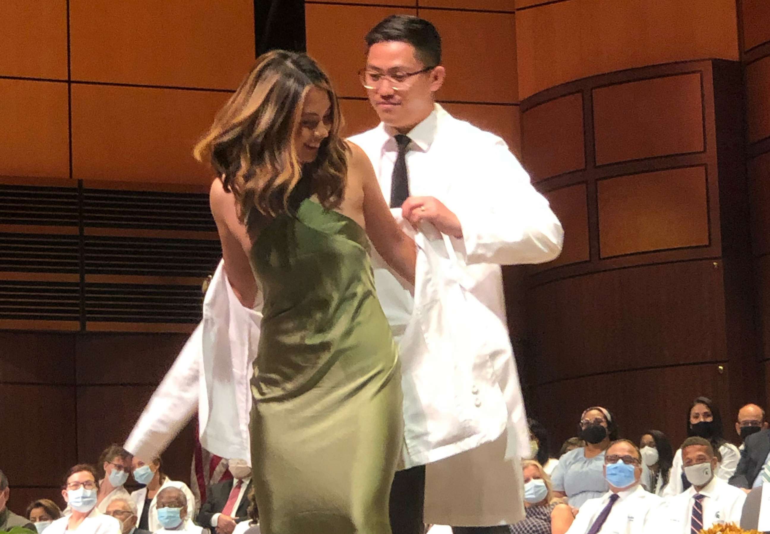 PHOTO: Maria Cielito Robles, a medical school student, chose her older brother, Carlito Robles, to give her her white coat. The white coat ceremony for medical school students marks the beginning of the journey to becoming doctors.