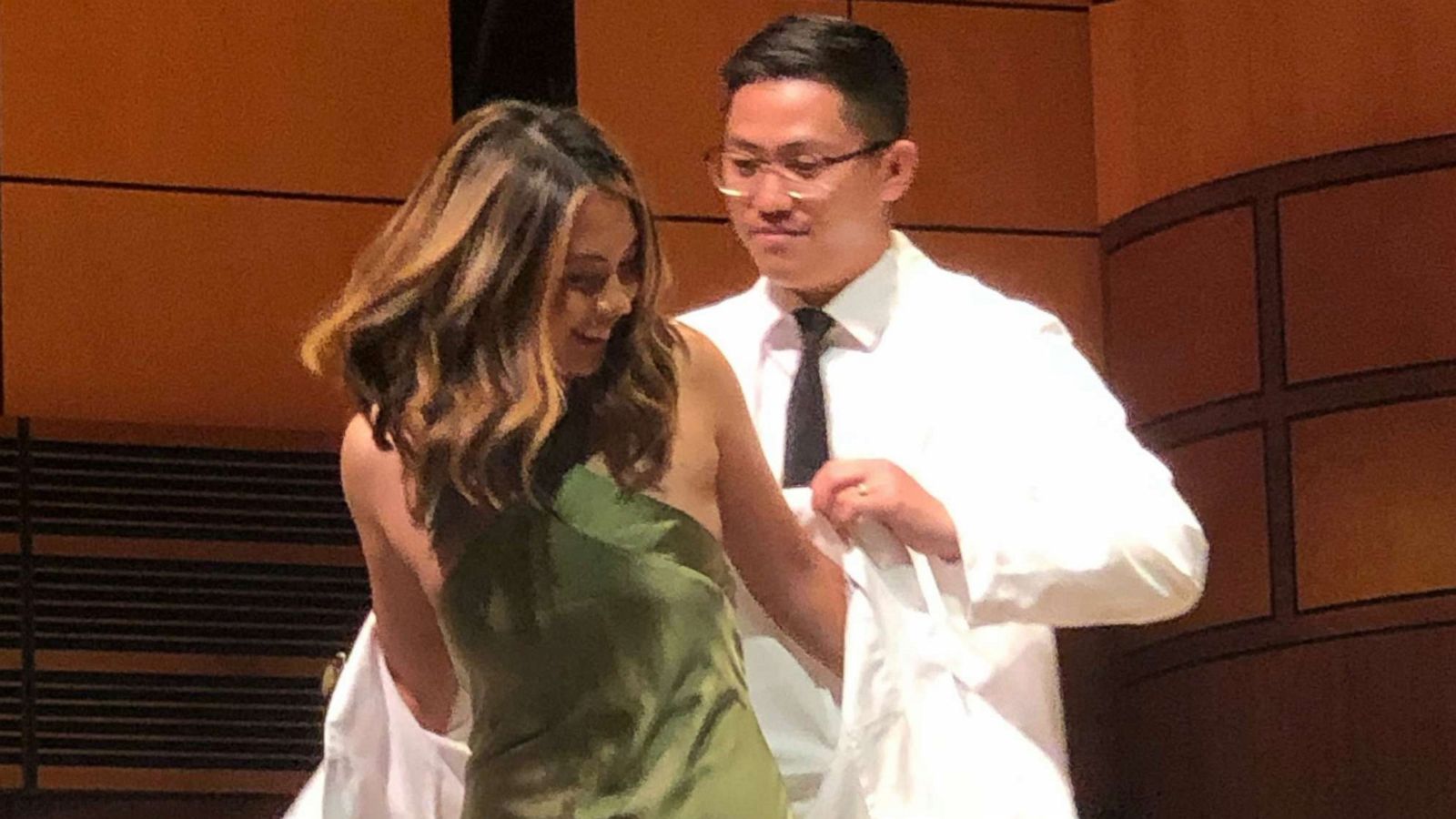 PHOTO: Maria Cielito Robles, a medical school student, chose her older brother, Carlito Robles, to give her her white coat. The white coat ceremony for medical school students marks the beginning of the journey to becoming doctors.