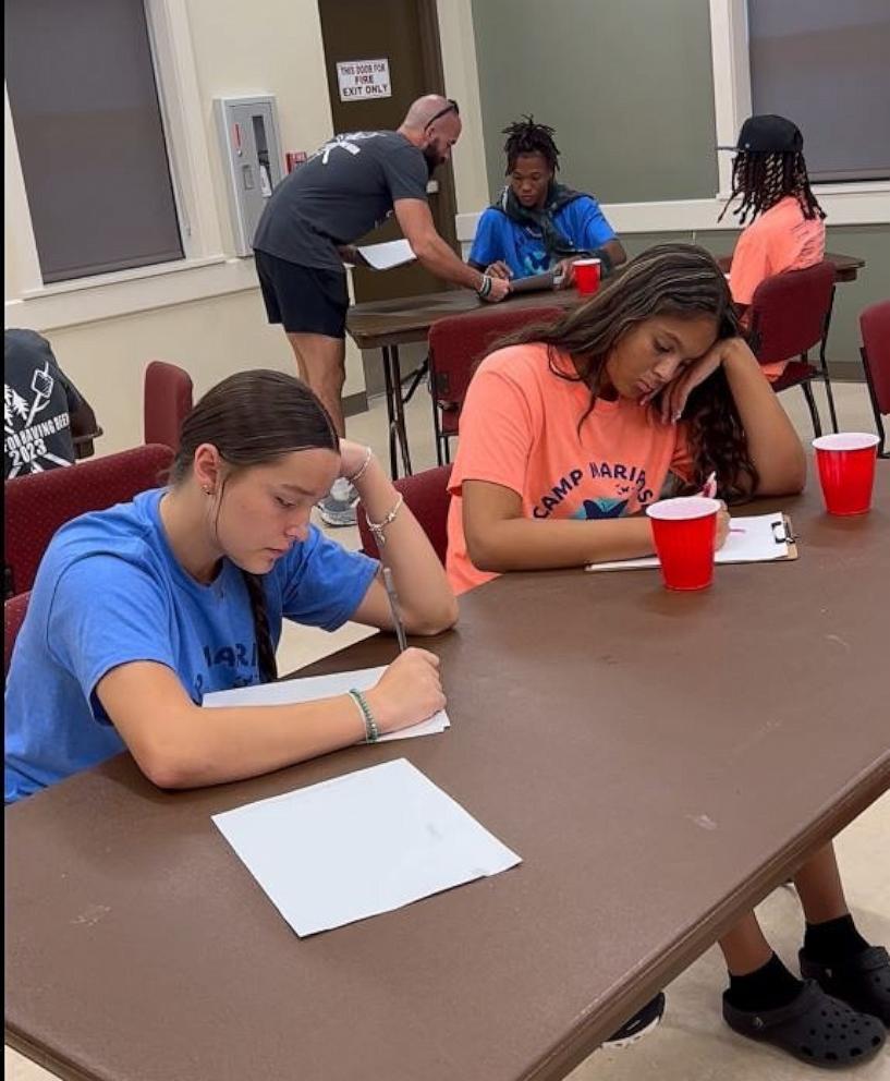 PHOTO: Madi, left, and Affera write letters to addiction at Camp Mariposa in Sarasota, Florida.