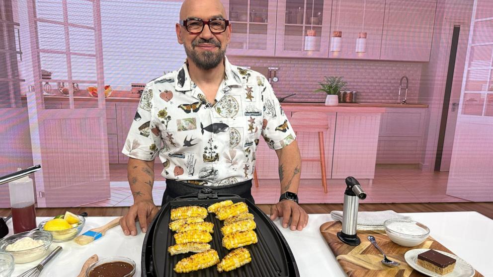 PHOTO: Chef Michael Symon grills corn for a Father's Day cookout on "Good Morning America."