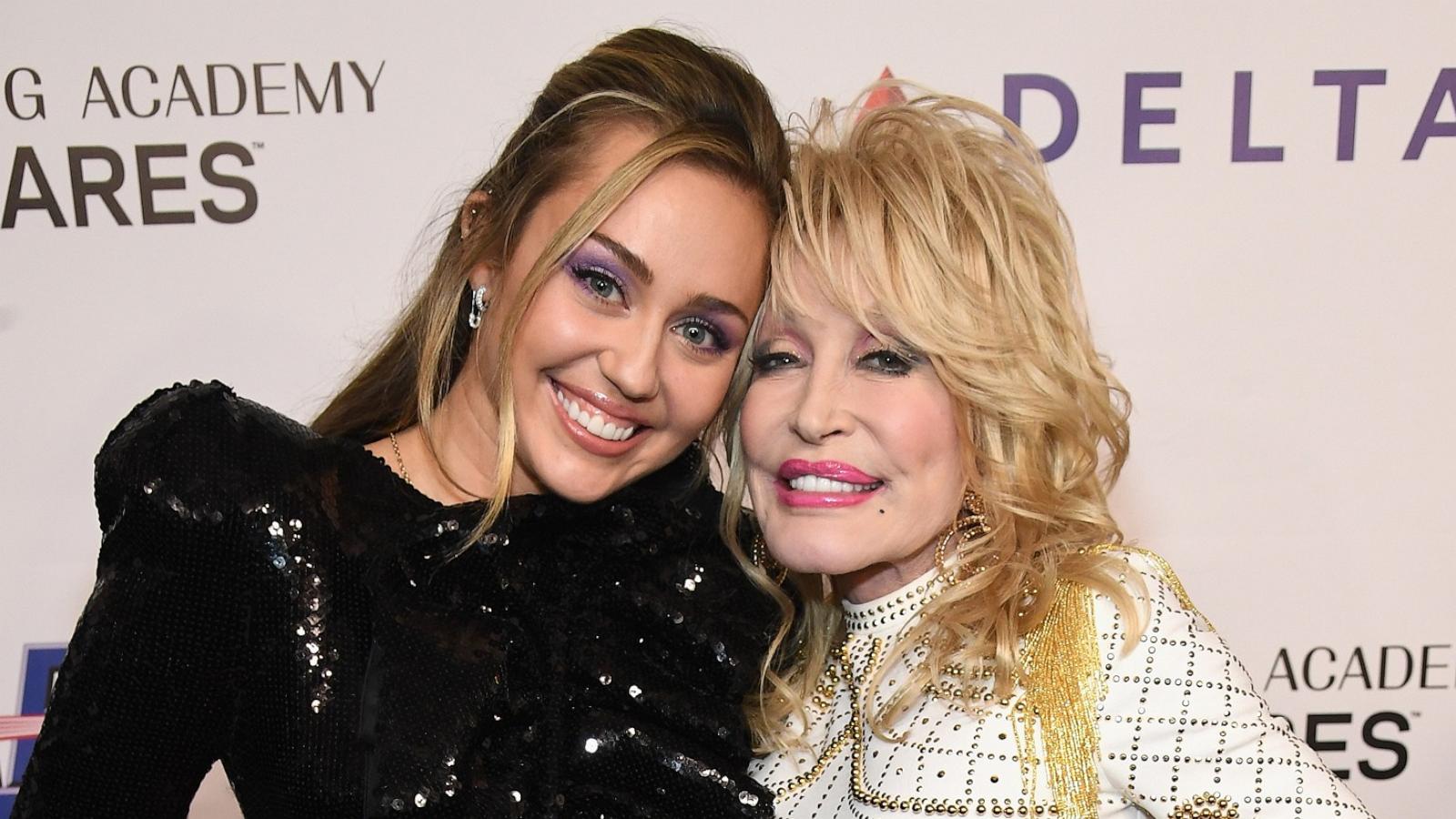 Miley Cyrus (L) and Dolly Parton attend MusiCares Person of the Year honoring Dolly Parton on February 8, 2019 in Los Angeles, California.