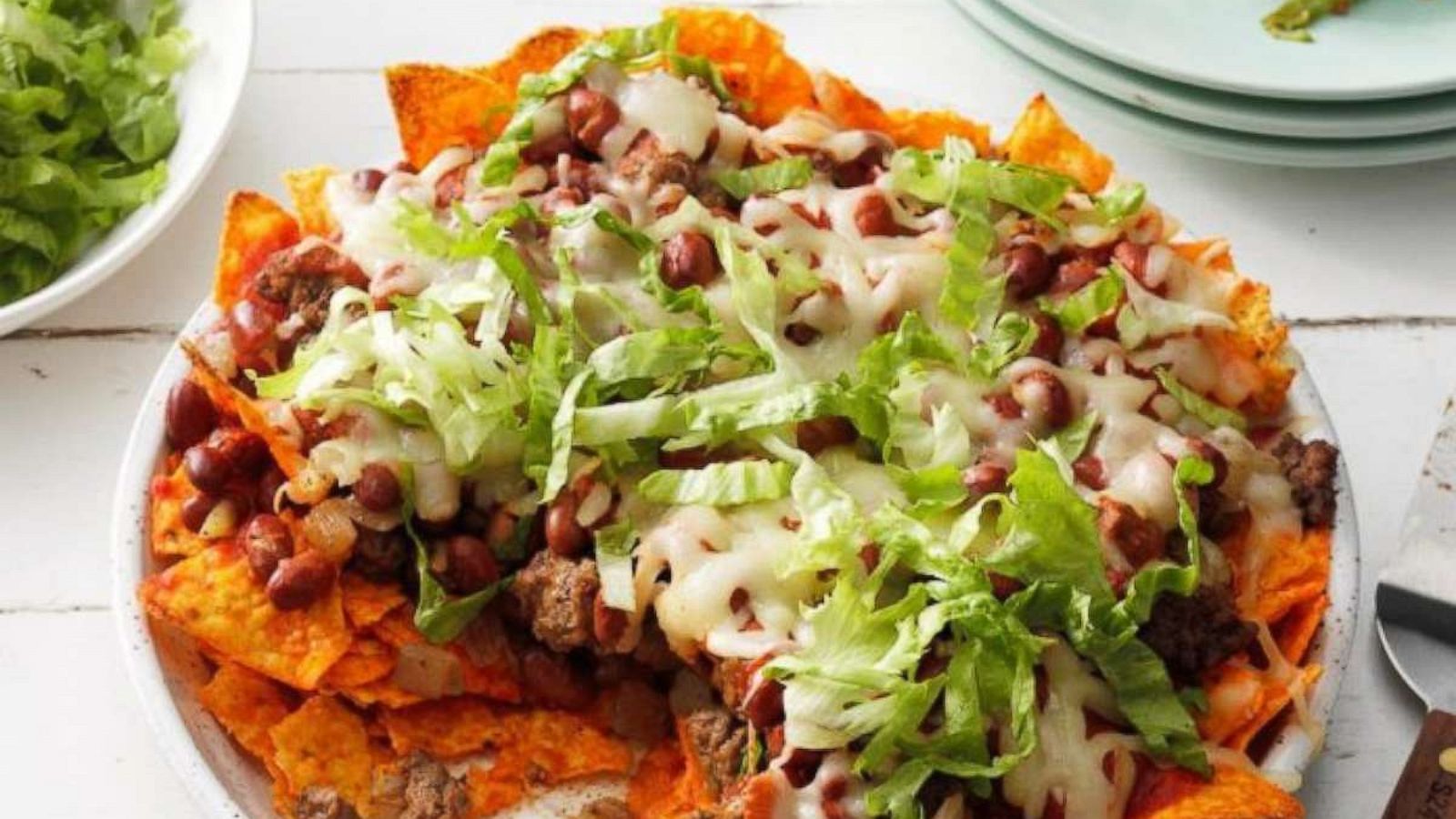 PHOTO: Nacho tortilla chips layered with ground beef, chili beans, and tomato sauce sprinkled with mozzarella cheese.